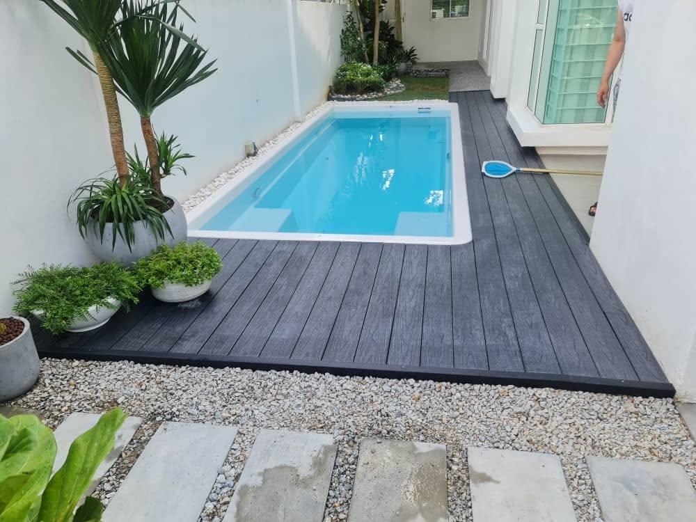 Poolside area featuring wood-look outdoor decking